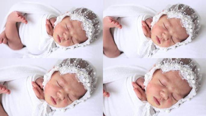一个刚出生的女婴穿着尿布，戴着白色背景上漂亮的帽子，甜甜地睡着了，一个婴儿的诞生，一个幸福的家庭