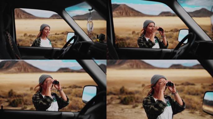 女游客用双筒望远镜观察摩洛哥的沙漠