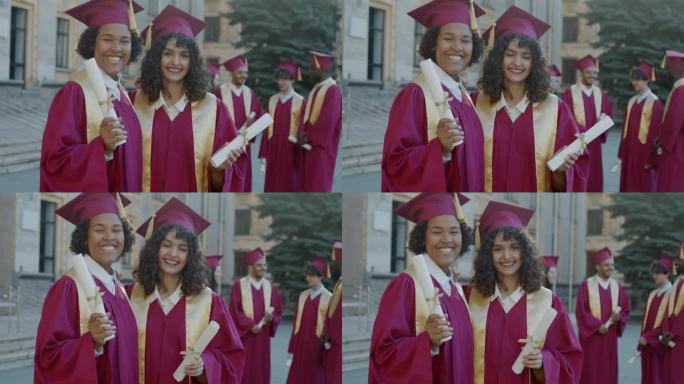 戴着毕业帽，穿着毕业礼服，站在校园里微笑的欢快年轻女性的慢动作肖像