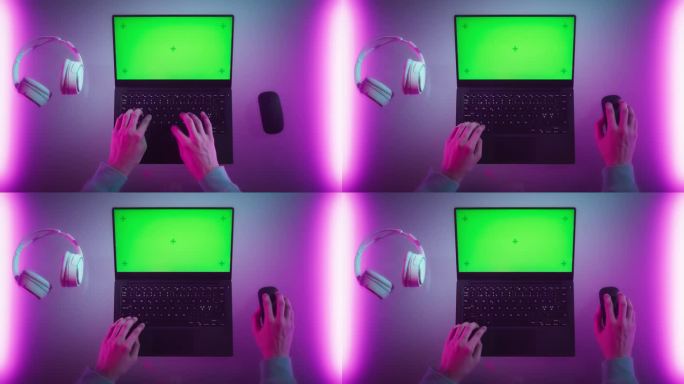 匿名设计师在笔记本电脑上打字，模拟绿屏Chromakey显示。软件开发人员或游戏玩家使用电脑，从事创