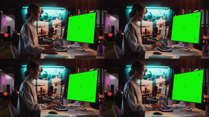 放大肖像的年轻女子坐在她的办公桌上使用台式电脑模拟绿屏。女性高加索专家工作与彩色键显示在创意机构的电