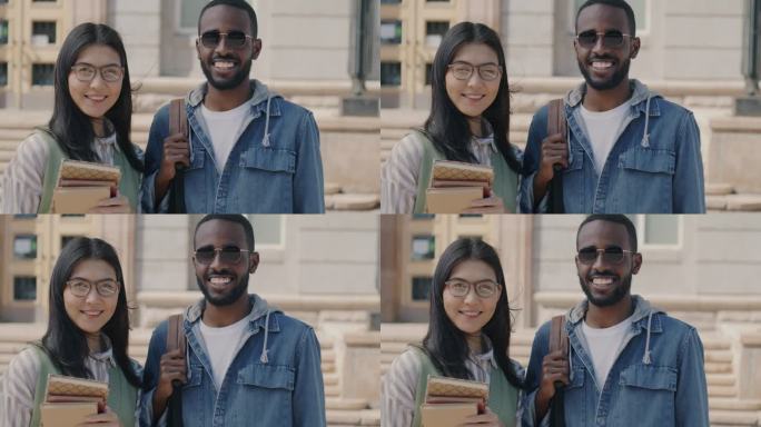 女生和男生站在大学大楼外，拿着书和背包微笑的慢动作肖像