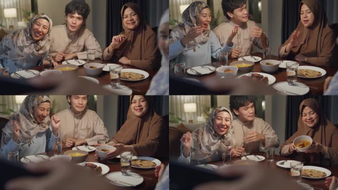 快乐的亚洲穆斯林家庭与表弟用手机视频在线庆祝异地斋月晚餐一起在家里。两代人一起庆祝开斋节。