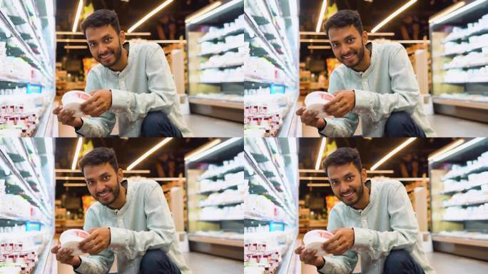 印度男子在杂货店买奶制品。帅哥买冰淇淋的侧视图