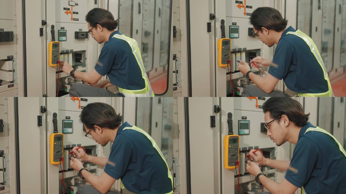 亚洲工程师在电器厂操作机械。