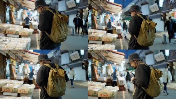 在日本东京，一名亚洲男子走在街头，环顾四周，购买食物。