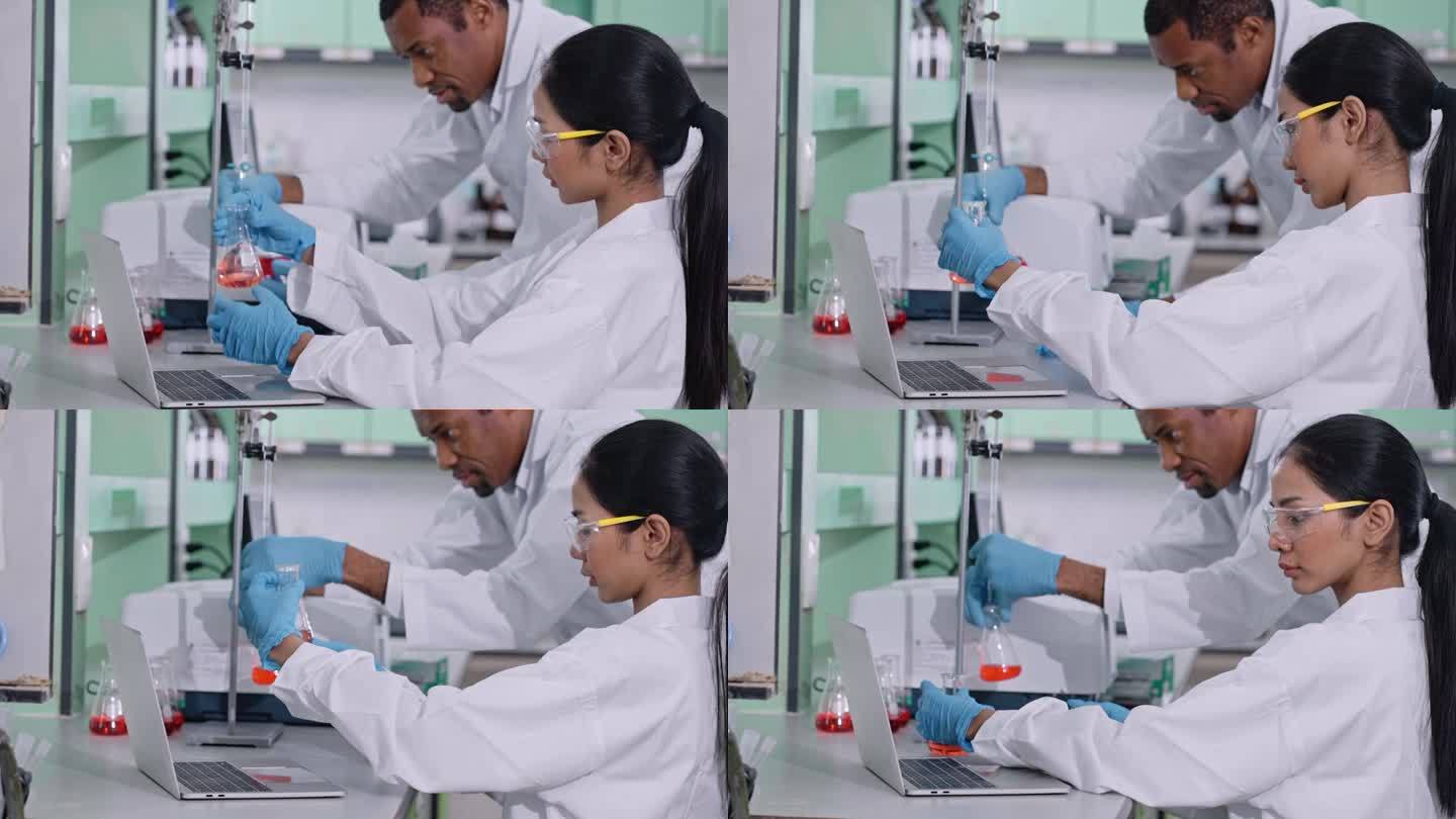 医疗技术人员正在观察显微镜。穿着实验室大褂的科学家在实验室工作。生物技术实验室的科学家检测烧杯中的液