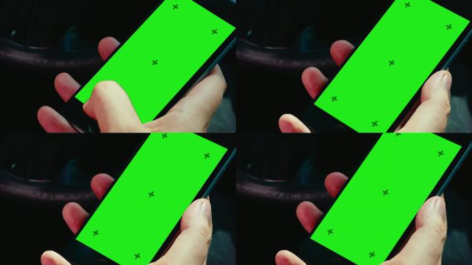 一名男子在车内用绿屏色度键解锁手机的特写镜头。垂直方向。