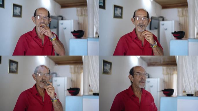西班牙裔老人的肖像，穿着红衬衫，抽着雪茄，在家里看着相机