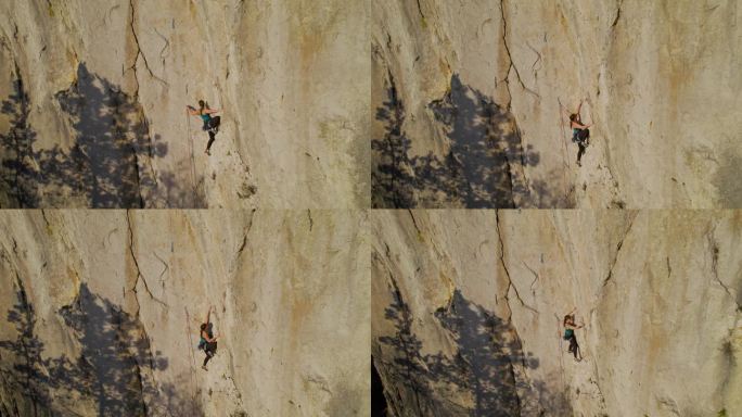 空中攀登:在艰难的攀登路线上，正在攀登的女性登山者