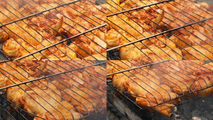 烧烤野餐时间在烤架上烤鸡腿和翅膀。烧烤肉在室外烤架网格美味的烤鸡排与烟火焰多汁的肉在后院