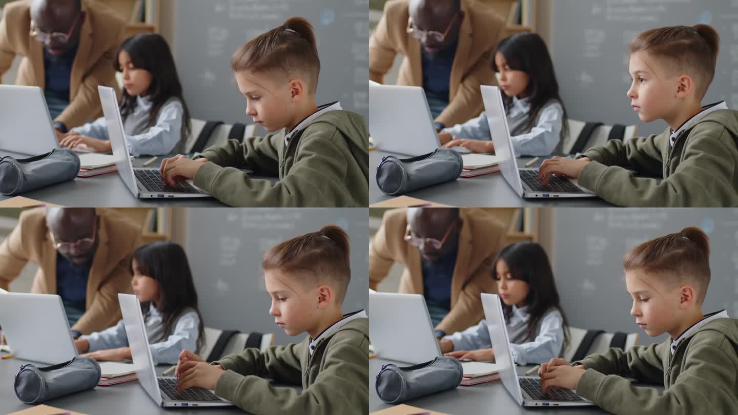 小学生坐在书桌前用笔记本电脑键盘打字