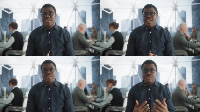 从镜头的角度看，英俊的年轻黑人项目经理在明亮的摩天大楼办公环境中进行视频通话。非裔美国男性专家通过现