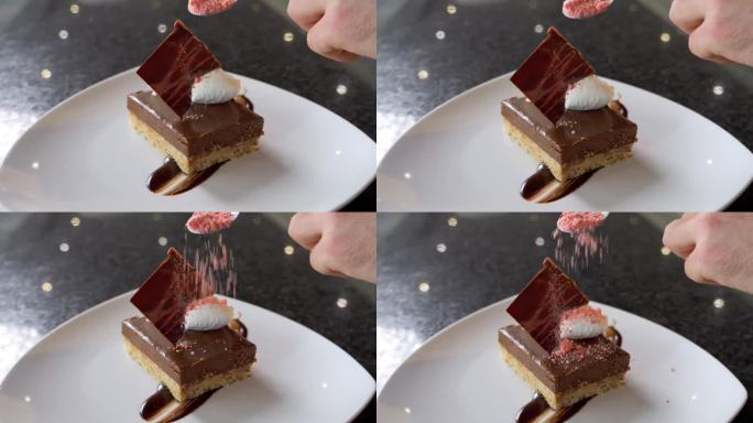 一位厨师为他的巧克力甜点添加最后的润色和配料的特写镜头