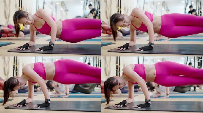一群亚洲女性在健身室进行锻炼，锻炼肌肉和身体健康