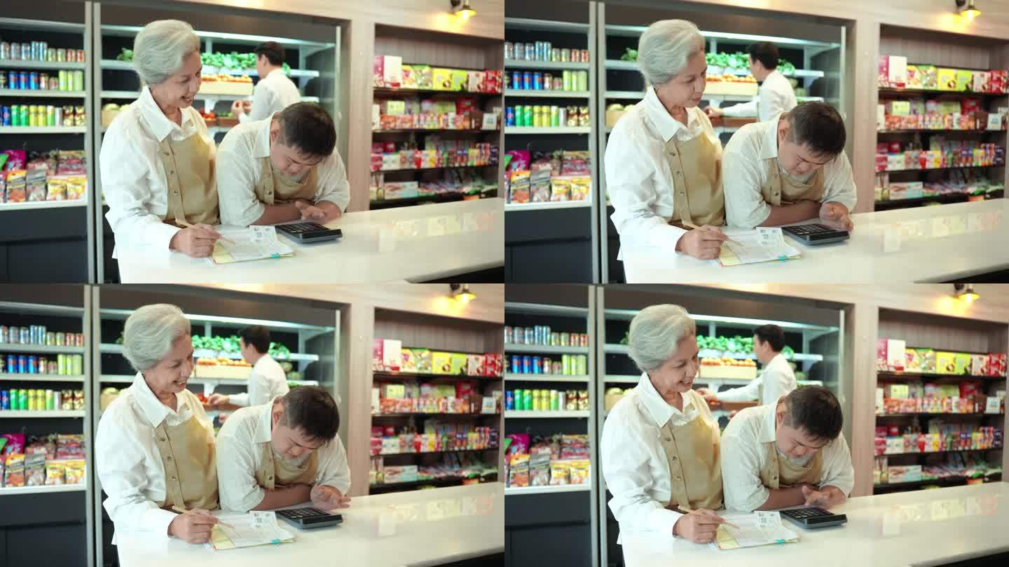 善良的资深女服务员站在柜台前，教她的同事，一个患有唐氏综合症的年轻亚洲人在超市计算账单。患有唐氏综合