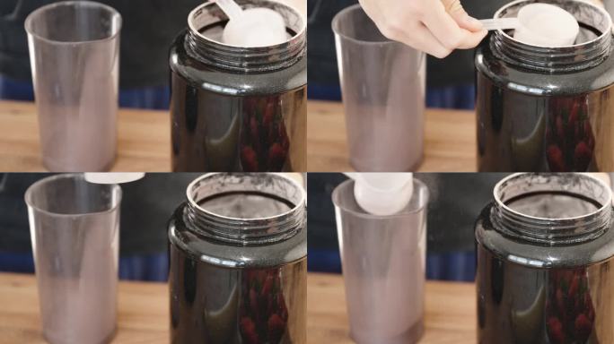 运动蛋白饮料，用量勺把粉末倒进杯子里，特写。