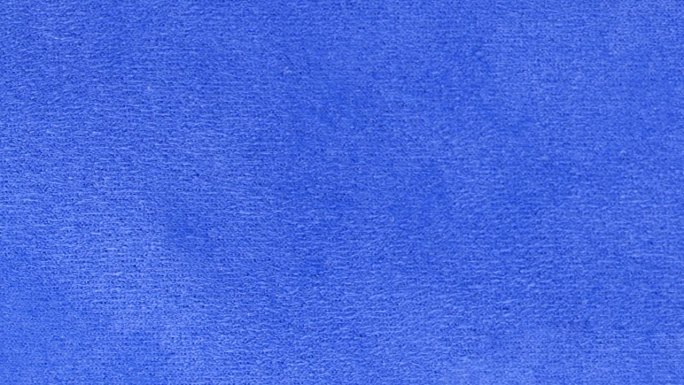 蓝色纹理织物布料特写，纺织品背景。从左到右的运动。