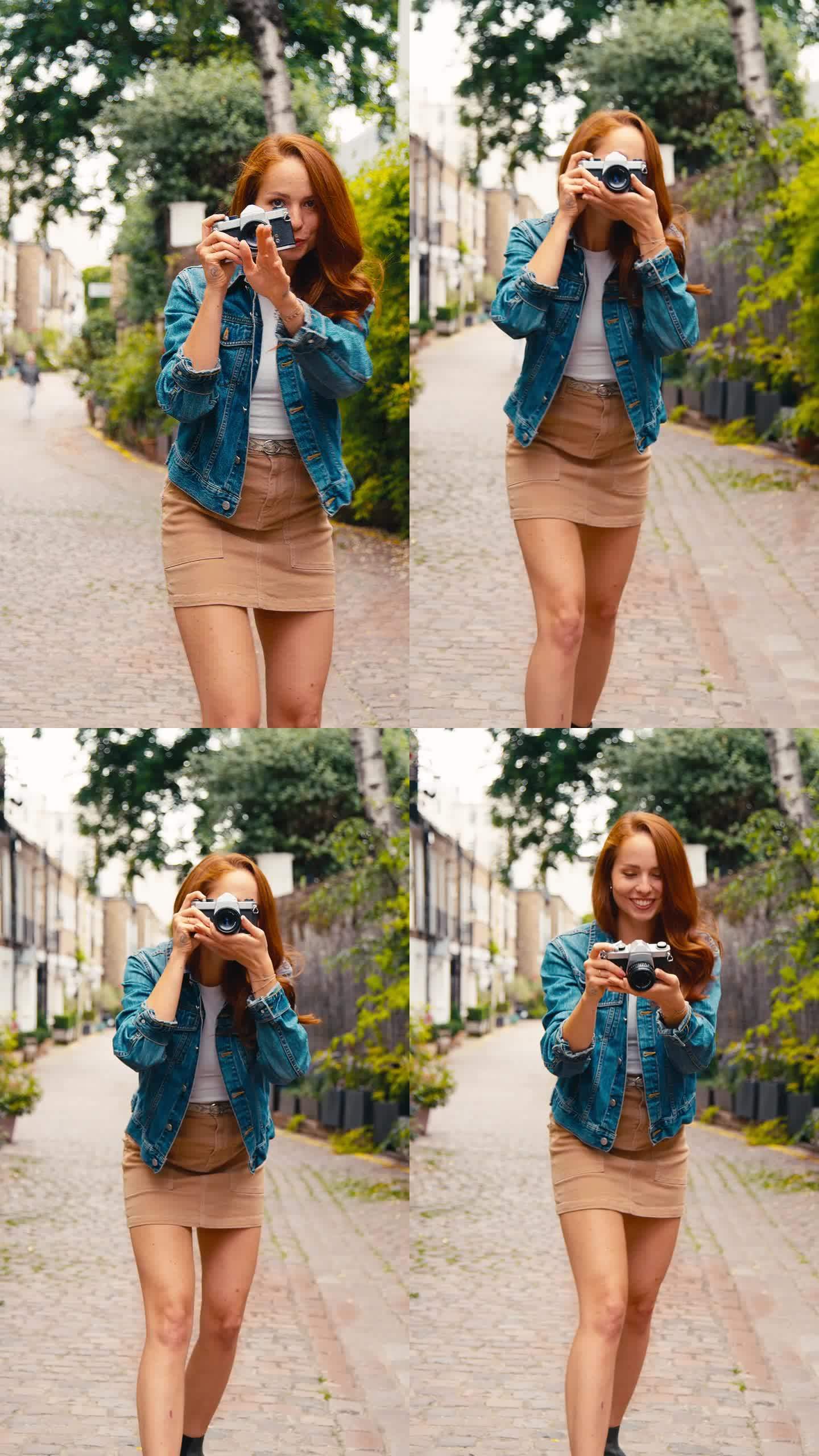 城市里年轻女子用数码相机拍照的垂直视频发布到社交媒体上