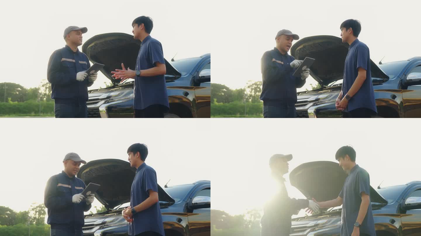 帅气的亚洲机械师在路边向亚洲客户展示平板电脑上的汽车报告，机械师和客户讨论他的汽车维修问题并握手。