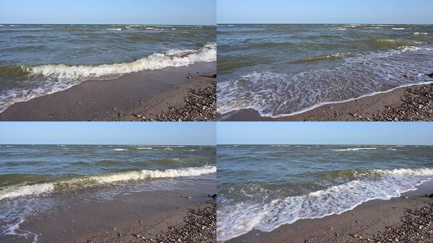 慢动作水波在大海和沙滩景观与蓝天，美丽的自然背景