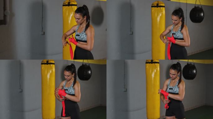 一位身穿运动服的年轻女拳击手在手上缠上防护绷带，准备进行拳击训练