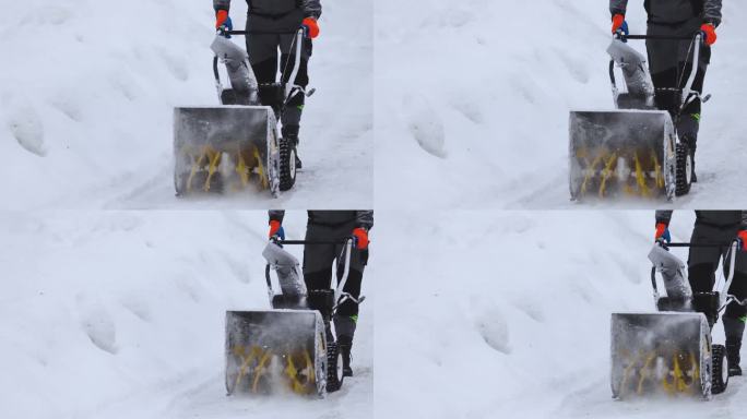 移动吹雪机除雪过程，大雪后的冬天，工人穿着工作服在街上用吹雪机除雪，慢动作