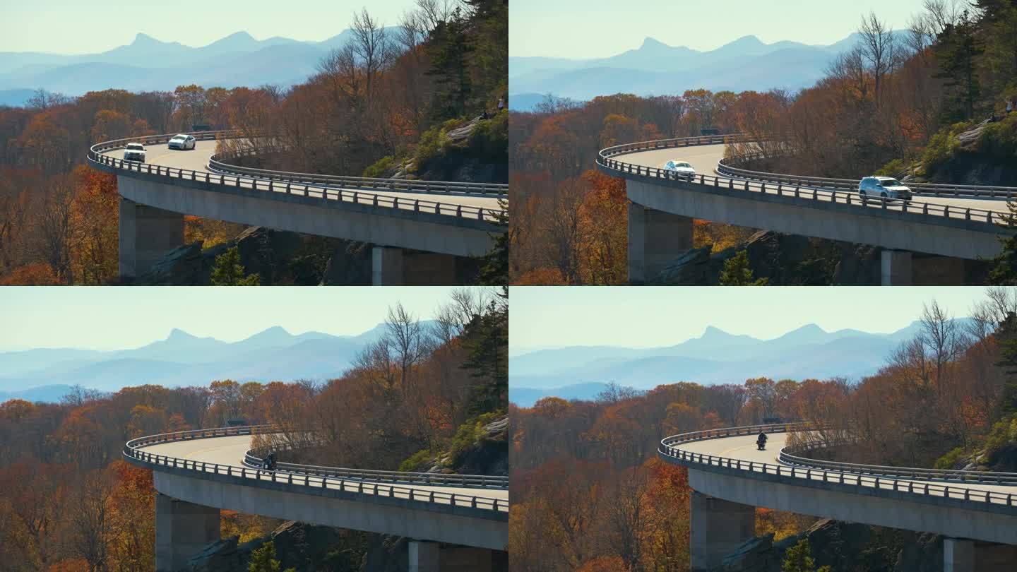 美国北卡罗来纳州蓝岭公园大道，吹石附近的林湾高架桥山景。在秋林间的风景公路上开车