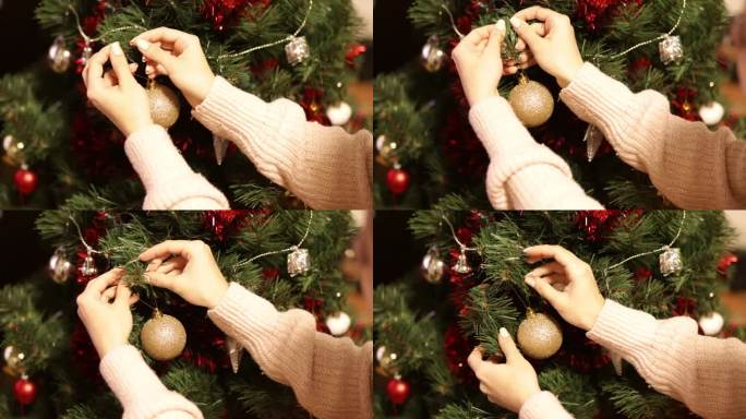 圣诞树装饰，女儿手把新年球挂在喜庆的树上