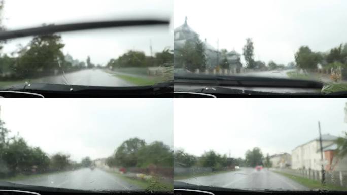 在乌克兰的一条公路上，一辆汽车上的雨刷擦去了一辆高速行驶的汽车上的雨水，这是一个夏日，从车内看，大雨