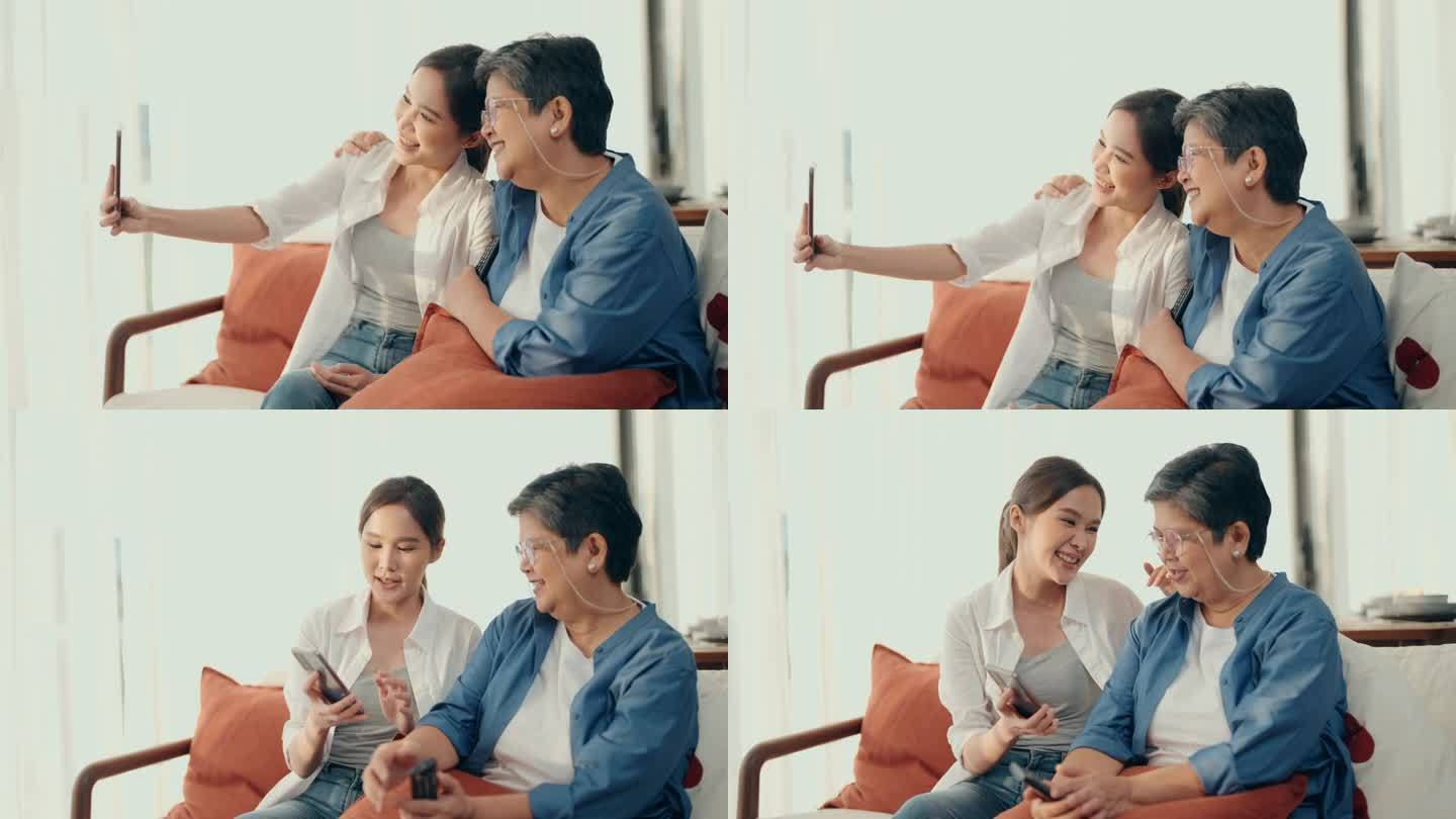 代际连接:亚洲老年妇女和女儿的快乐时刻，在看电视时分享笑声和正能量