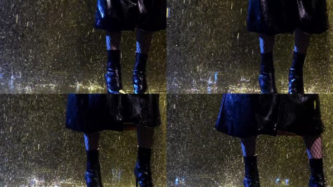 穿着靴子和雨衣的女人踩在潮湿的地板上