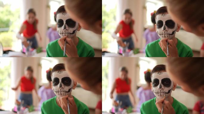 一个男孩正在为亡灵节化妆成一个糖骷髅