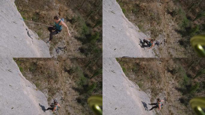 特写:女攀登者在攀爬岩壁时因抓不住而摔倒