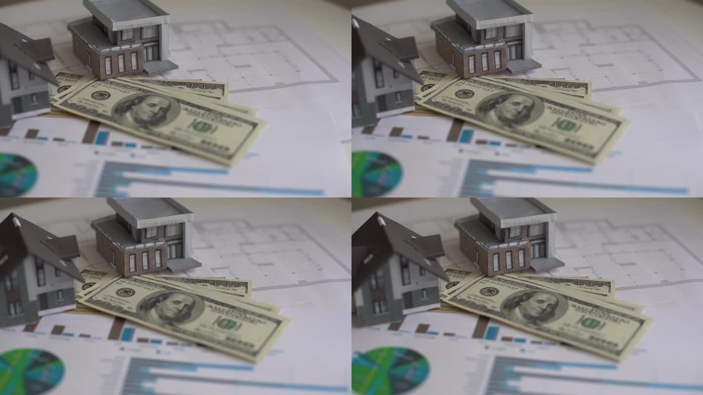 房屋模型印在100美元钞票上。把钱或投资存起来盖新房子