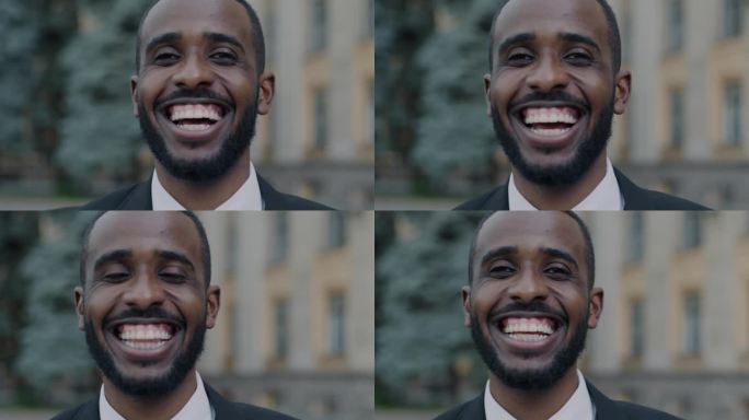 大喜过望的非裔美国学生在城市户外欢笑的特写肖像