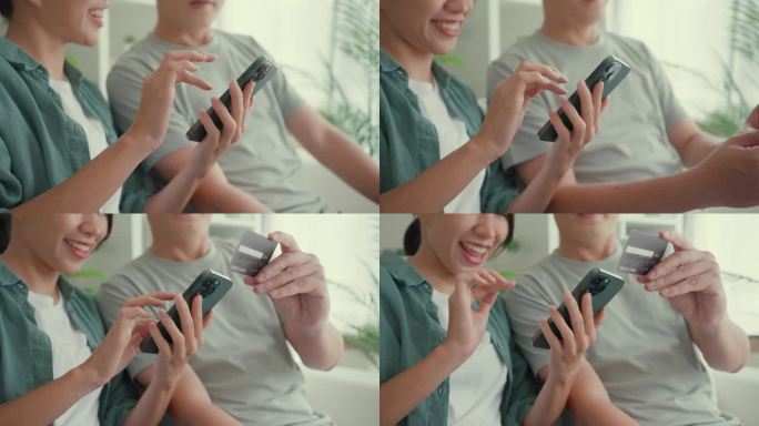 幸福的亚洲夫妇的特写，他们一起坐在家里客厅的沙发上玩智能手机购物，使用信用卡在线支付。生活方式花时间