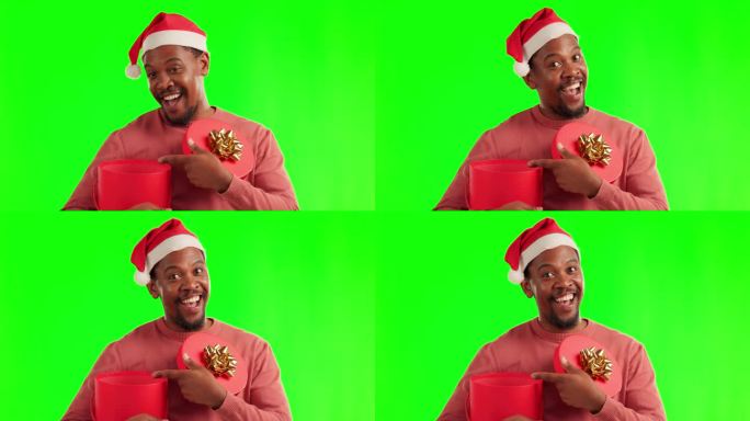 惊喜，绿幕和一个男人带着圣诞礼盒和圣诞老人的帽子，一脸震惊地出现在演播室里。快乐，现在和肖像的非洲男