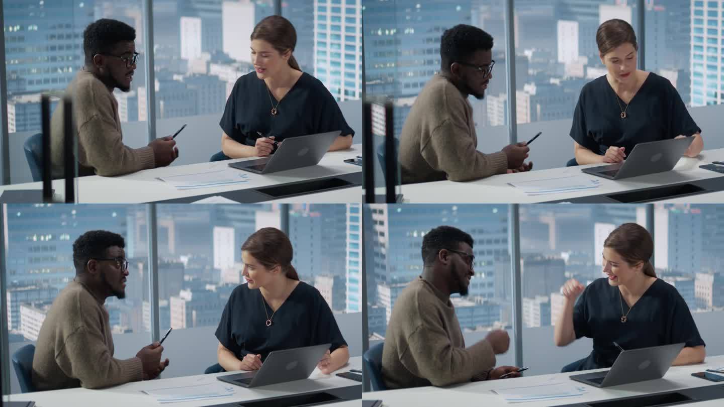 摩天大楼办公室的商务人士:两位经理使用笔记本电脑的商务会议。女性CEO和非裔美国运营总监成功完成一项