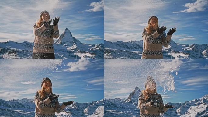 一个女人向空中抛雪，背景是马特洪峰