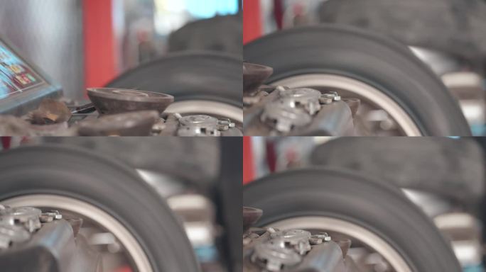 技师或机械师在修理汽车方面具有专业知识和技能，在车库里给合金车轮装上新轮胎后，使用特殊的机器来测试旋