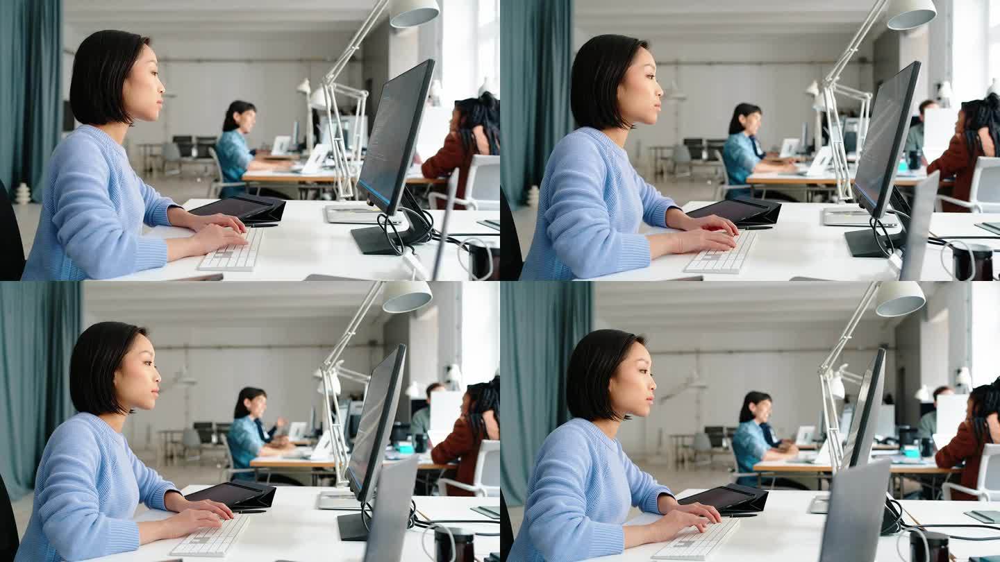 女软件工程师在联合办公办公室做电脑工作