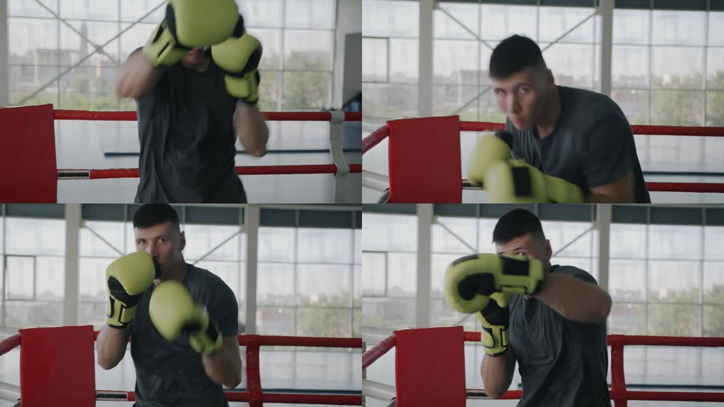 肌肉发达的运动员拳击手在健身房训练的慢动作肖像，戴着手套击打空气，看着镜头
