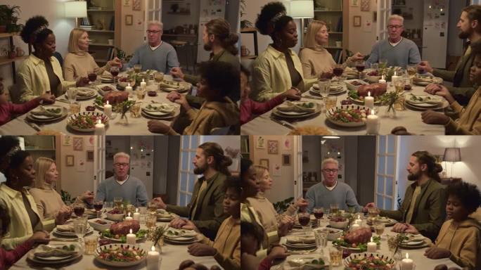 感恩节期间一家人围坐在餐桌旁祈祷