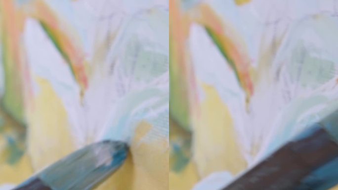 女艺术家手握画笔画油画的特写镜头。色彩缤纷，情感油画。当代画家创作现代抽象美术作品