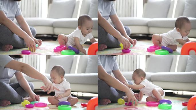 妈妈带着8个月大的小男孩在家里玩着五颜六色的玩具，玩得开心又有趣
