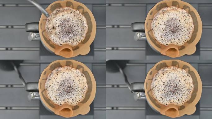 咖啡师用滤纸将热水倒在咖啡粉上，制成滴滤咖啡。