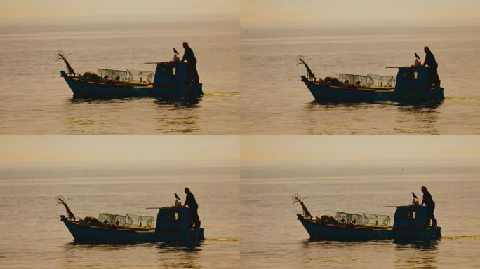 日落时分，在拖网渔船上航行的人。在克罗地亚伊斯特拉，一名渔民在一艘帆船上划船