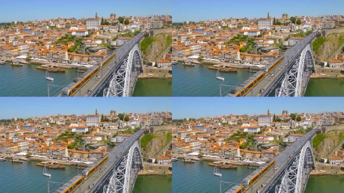 在葡萄牙波尔图的杜罗河上，地铁列车行驶在多姆·路易斯一世桥上，人行道上有行人。广角镜头