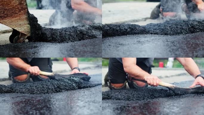 道路施工工人在铺路工处手动在地面上铺装和调整热沥青或沥青